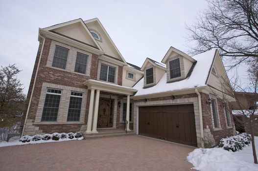 Majestic Newly Constructed Home Facade on a Blustry Winter Day