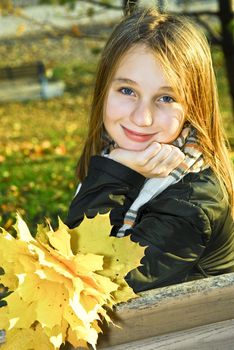 Portrait of a beautiful teenage girl in fall park