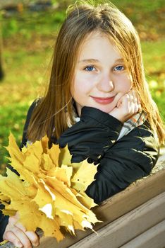 Portrait of a beautiful teenage girl in fall park