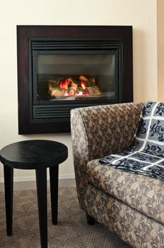 Fireplace and cozy armchair in living room