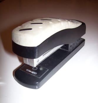 Standard office stapler on a white background