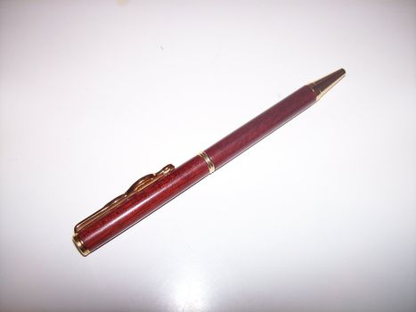 A wooden pen against a white background