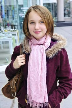 Teenage girl window shopping on city street