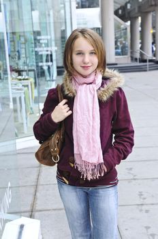 Teenage girl window shopping on city street