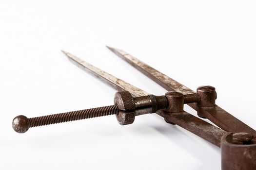 The ancient measuring tool for joiner's works on a white background.