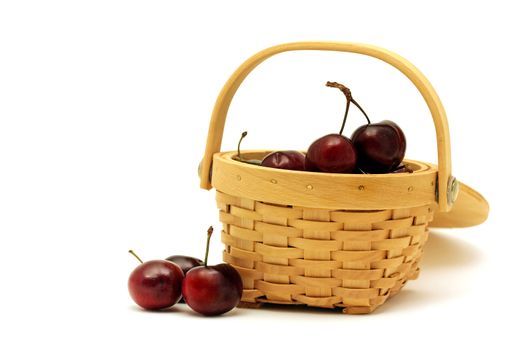 Basket full of cherries isolated on white