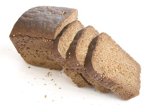 Loaf and slices of black bread with carum on white background