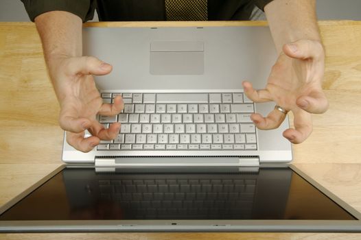 Businessman shows his frustration while working on his laptop.