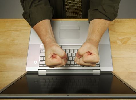 Businessman shows his frustration while working on his laptop.