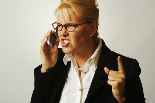 Business woman expresses her anger while on her cell phone.
