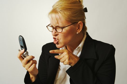 Business woman expresses her anger while on her cell phone.