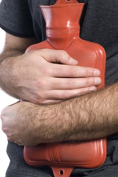 Close-up view of somebody holding a hot water bottle to soothe their sore stomach