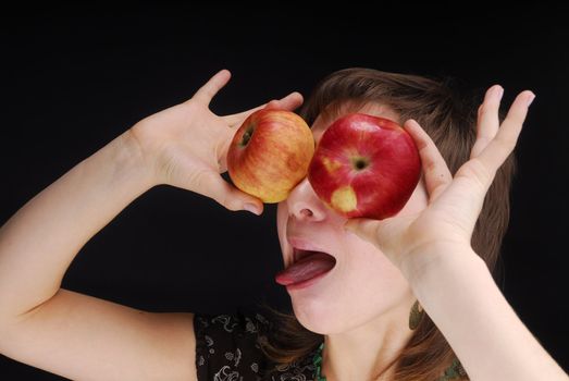 Woman with apple near her eyes