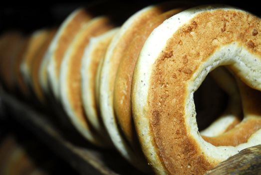 Many bagels on shelf in bakehouse