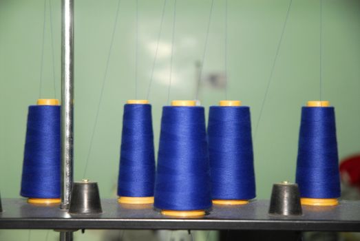 Blue bobbin on professional sewing-machine 