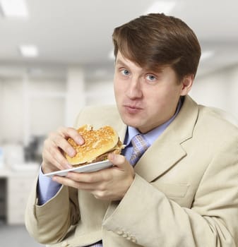 The young businessman is the dinner isolated on a white background