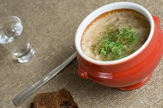 soup served in a ceramics pot, shallow DOF