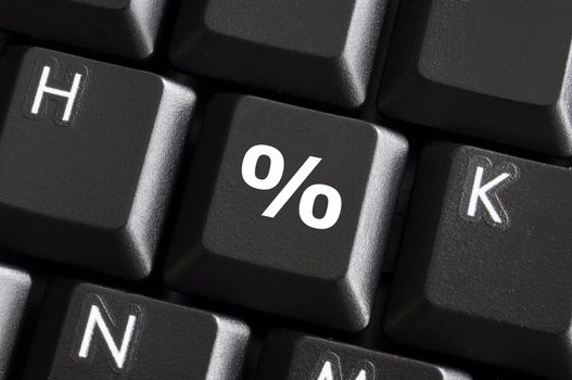 percent sign on computer keyboard showing discount concept