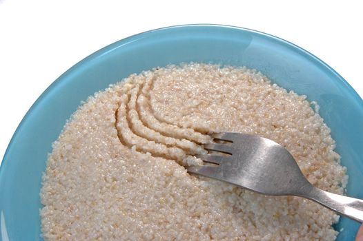 groats porridge in  plate on white