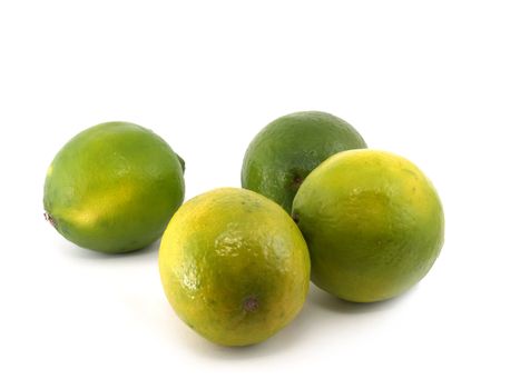 Four green limes on the white background