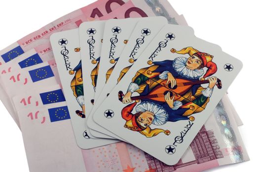 Five card jokers are resting on 10 euro bills.
isolated on a white background