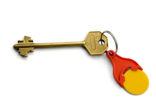 Isolated bronze key with red key ring for coins On White background