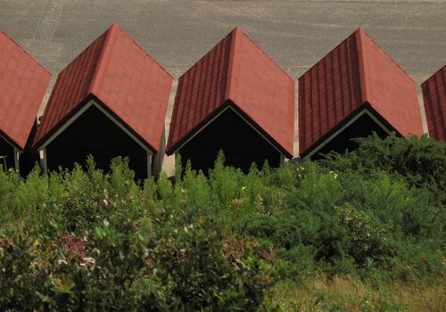 Generic row of beach hut roofs taken from cliff above