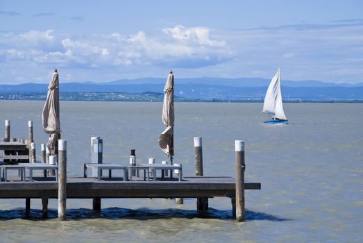 Sailing boat and pier at a lake