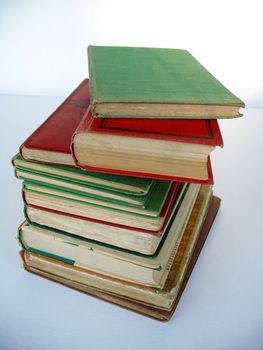 A pile of antiquarian hardcover book. Mainly red and green in colour