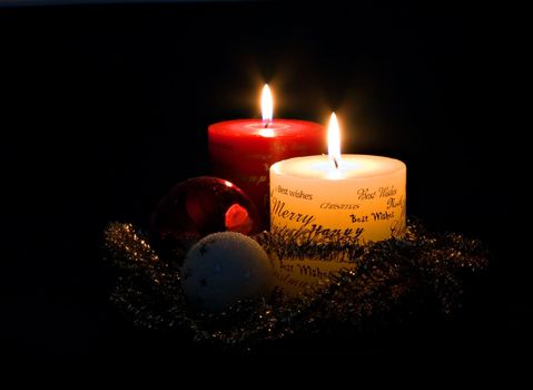 Christmas candles and ornaments on black