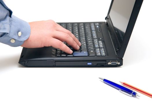 hand typing on laptop over white background.
