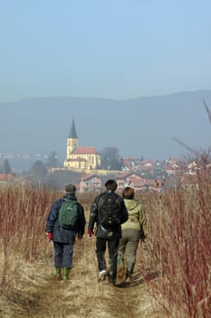 Three people walking in the fields