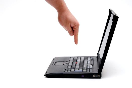 hand pressing key on laptop.