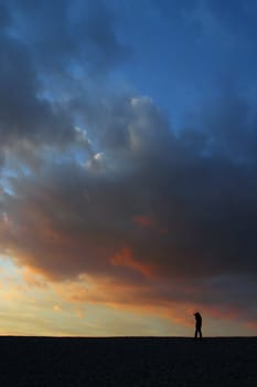 Beautiful sunset sky with man silhouette