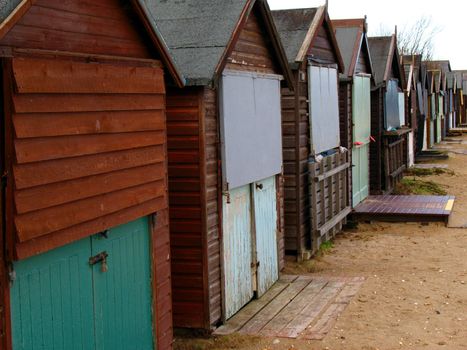 A row of beach huts on sand dunes. Deserted during the winter months.