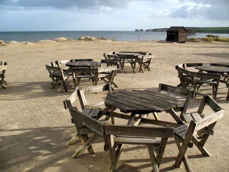 View of seashore with tables and eating area