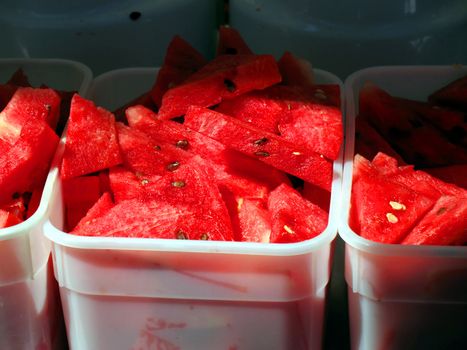 Outside catering at Thai Culture Festival. Caterers tubs of fresh, sliced, watermelon.