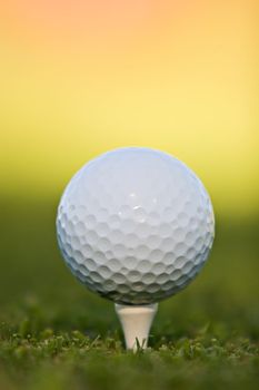 Golf ball on tee, extreme close-up.