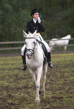 Smoking girl horseback riding English style.