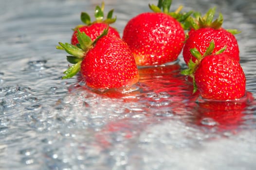 The first ripened strawberry on a background of the blue sky