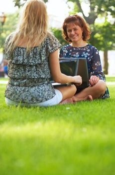 European students doing homework on their laptops