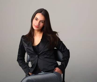 A young attractive woman sitting on armchair