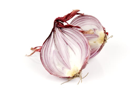 Raw red onion cut in half on a reflective white background