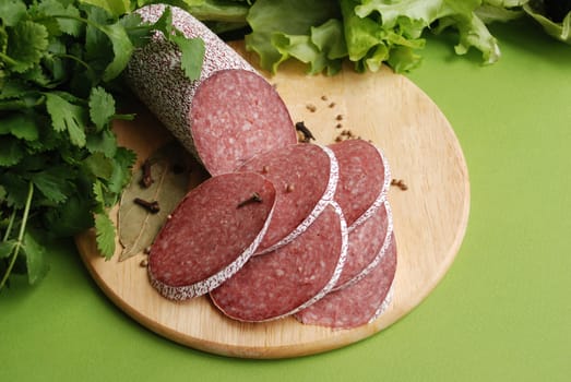 Salami sausage and lettuse close up.