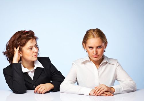 Pretty confident business women against light background