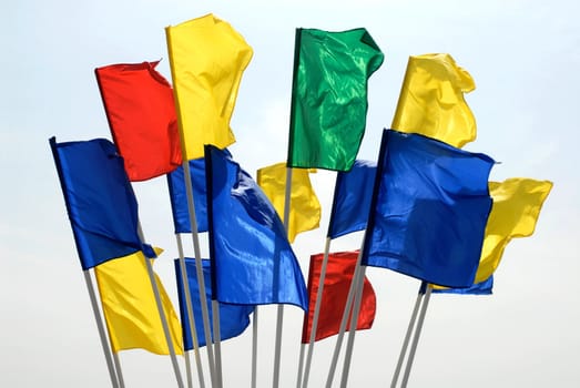 Different colours flags on sky background