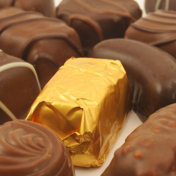 chocolate truffles in a golden gift or present box