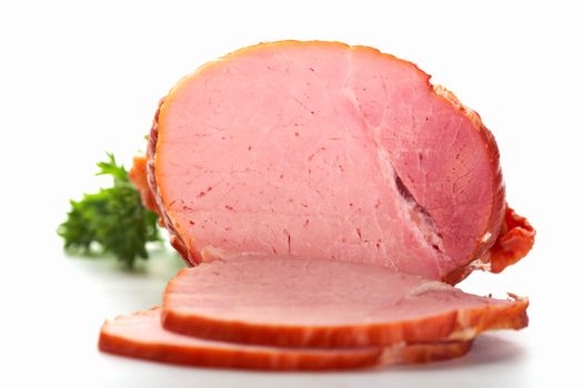 A close-up picture of ham with two cutted slices.