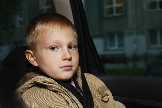 The serious boy in the automobile