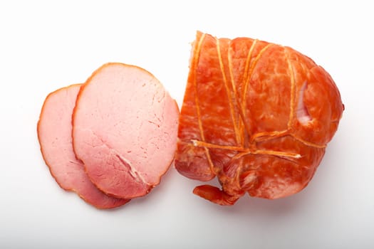 A close-up picture of ham with two cutted slices.